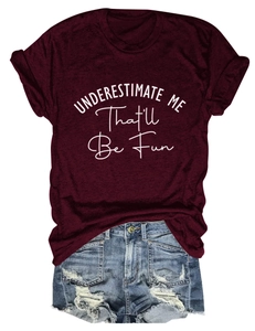 Flat lay of burgundy crew neck t-shirt with slogan and distressed denim shorts