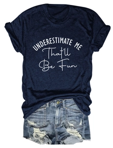 Flat lay of navy cotton T-shirt with 'UNDERESTIMATE ME' text and distressed denim shorts