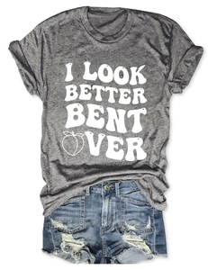 Detail of grey crewneck tee with I Look Better Bent Over text and distressed denim shorts