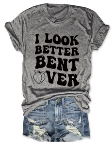 Flat lay of gray cotton T-shirt with graphic print and blue ripped denim shorts