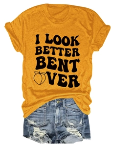 Flat lay of mustard yellow t-shirt with text print and distressed denim shorts