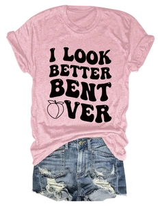 Detail view of pink cotton t-shirt featuring bold black text and creative peach graphic
