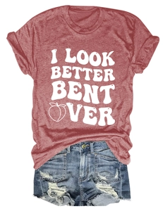 Detail view of brick red t-shirt with slogan and ripped denim shorts on white background