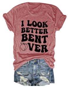 Flat lay of maroon t-shirt with I LOOK BETTER BENT OVER print and ripped denim shorts