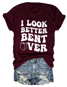 Flat lay of burgundy t-shirt with white text print and distressed denim shorts