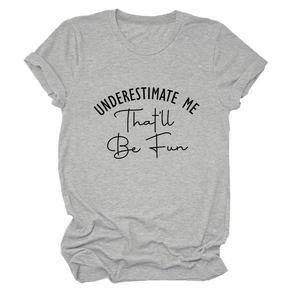 Detail of grey crewneck T-shirt with UNDERESTIMATE ME slogan print on cotton fabric