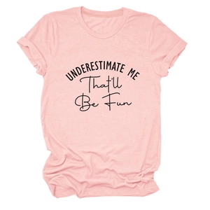 Pink cotton t-shirt detail showing the black printed slogan Underestimate Me That'll Be Fun