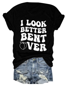Flat lay of black cotton T-shirt with peach graphic and blue ripped denim shorts set