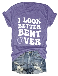 Detail of purple graphic t-shirt with peach icon and distressed denim shorts outfit