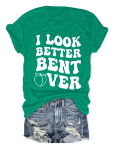 Detail of green cotton T-shirt with I LOOK BETTER BENT OVER print and ripped denim shorts