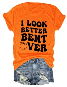 Flat lay of orange crew neck T-shirt with black text and distressed blue denim shorts