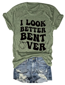 Army green t-shirt with peach graphic and blue ripped denim shorts in flat lay view