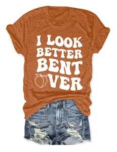 Flat lay of rust red round neck T-shirt with text and distressed blue denim shorts