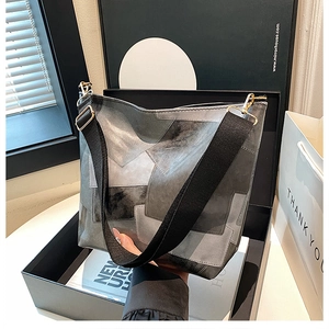 Detail of gray and black two-tone tote bag with wide strap in a gift box