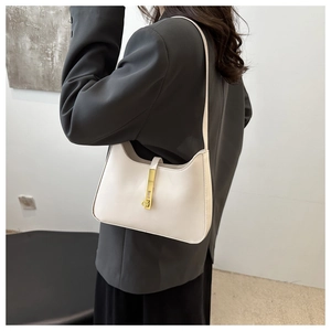Close-up of sleek white crescent hobo bag with elegant gold buckle and glossy texture