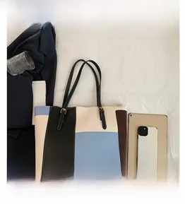 Top view of large color-block tote bag with adjustable straps and metal buckles