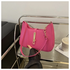 Detail of fuchsia crescent bag with premium PU texture and gold metal buckle hardware