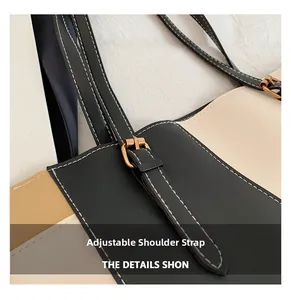 Detail of adjustable shoulder strap with gold buckle and stitching on contrast tote bag