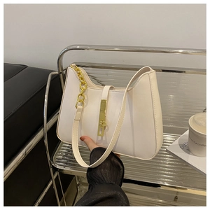 Detail of white PU leather underarm bag featuring a gold metal buckle and chunky chain