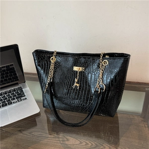 Chic black crocodile embossed tote bag with gold deer pendant and chain handle