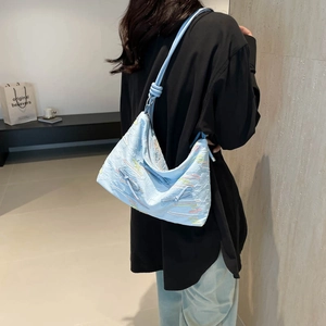 Minimalist light blue crossbody bag with embroidery and knot shoulder strap detail