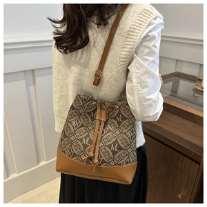 Detail of vintage monogram bucket bag with jacquard canvas and leather drawstring