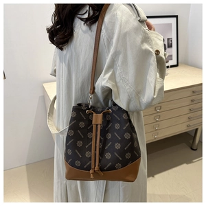 Detail of vintage monogram bucket bag with leather drawstring and textured canvas finish