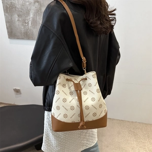 Retro bucket bag with brown monogram pattern and adjustable leather shoulder strap