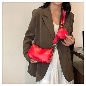 Detail of red PU leather hobo bag with matching mini round pouch and wide shoulder strap