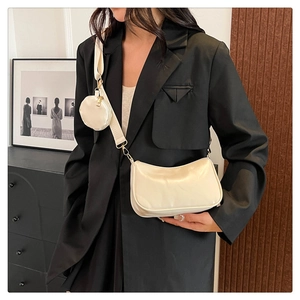 Detail of cream white half-moon crossbody bag with wide strap and coin purse