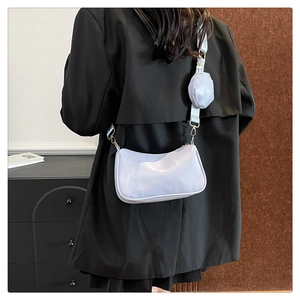 Detail view of lavender crescent crossbody bag with mini round coin purse attachment