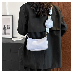Close-up of light blue crossbody shoulder bag set with a round coin purse on a black blazer