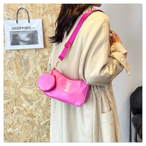 Detail of pink crossbody bag with detachable round coin purse and adjustable wide strap