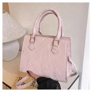 Macro view of pink PU leather tote with unique marble texture and golden hardware