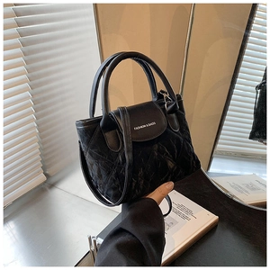 Detailed view of black quilted faux leather handbag with Fashion & Bags lettering