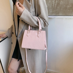 Pale pink patent leather tote bag with glossy finish and detachable shoulder strap for women