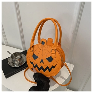 Detail of orange pumpkin crossbody bag with black jack-o-lantern face and spider web print