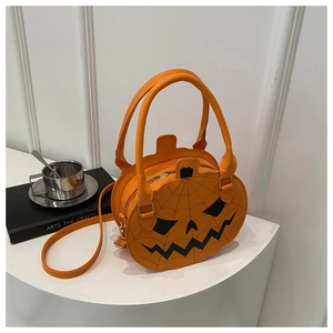 Detail of Halloween pumpkin shaped bag in orange PU leather with black spider web pattern
