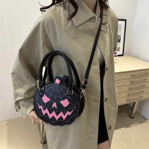 Halloween pumpkin crossbody bag with pink spiderweb design on a black PU leather base