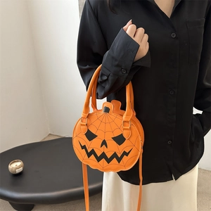 Chic orange pumpkin crossbody bag with black face print and spiderweb design for Halloween