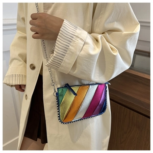 Detail of colorful metallic stripe crossbody bag with silver studs and chain strap