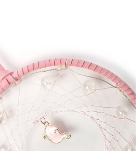 Nahaufnahme eines rosa Traumfängers mit LED-Lichtern und süßem Geist-Anhänger-Detail