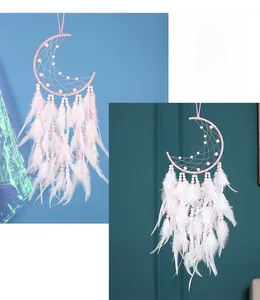 Close-up of pink moon dreamcatcher featuring delicate white feathers and woven beads details