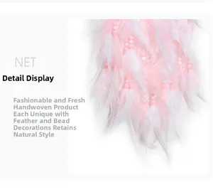 Close-up of pink and white feathers with beads on handmade moon dreamcatcher