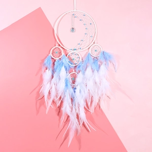 Blue and white dream catcher with moon weave, feathers, and beads for home wall decor