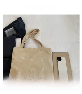 Detail view of large corduroy tote bag with Our Future embroidery and spacious interior