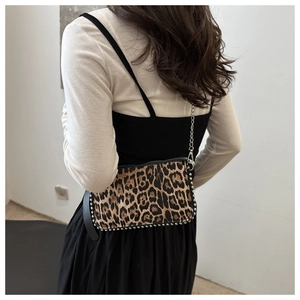 Detail of leopard print shoulder bag with silver studs and metal chain strap
