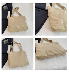 Detail of beige corduroy tote bag showing 'Our future' embroidery and reinforced handles