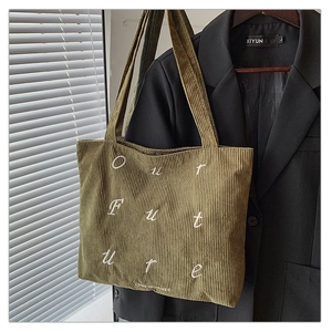 Detailed texture of olive green corduroy tote bag with Our Future embroidery