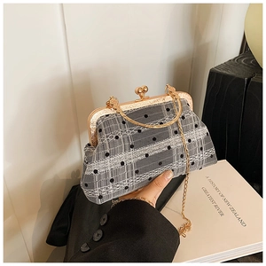 Vintage shell-shaped handbag with black polka dot mesh and gold metal chain strap